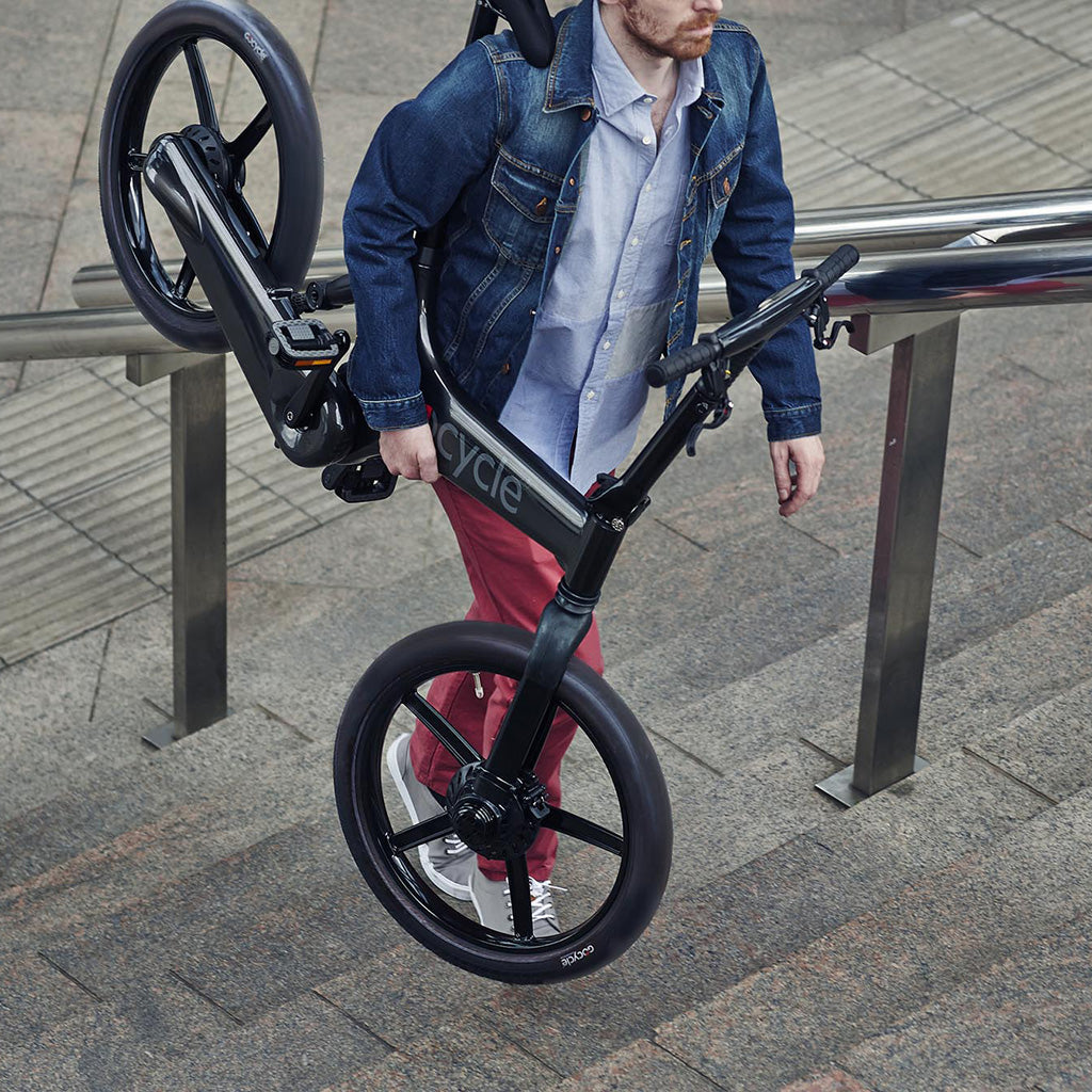A man carrying an Gocycle electric bike