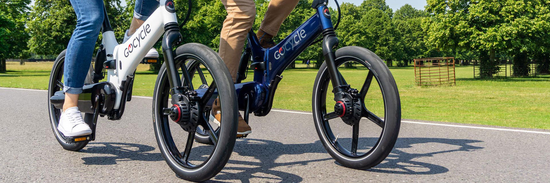 Two people riding Gocycle folding electric bikes