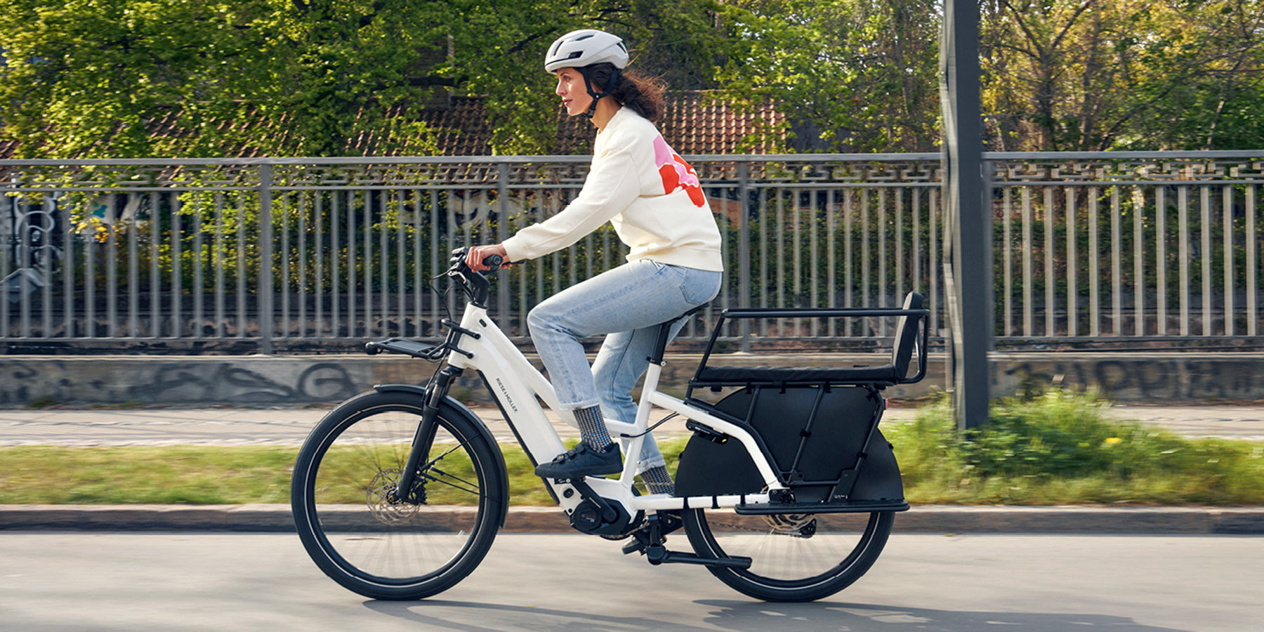 A woman riding a Riese and Muller Multicharger2 Mixte electric bike