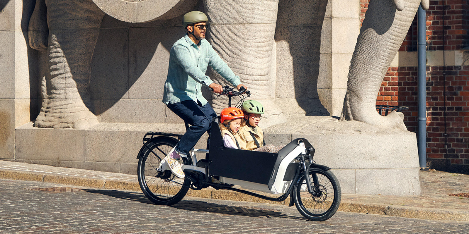 A man riding a Riese and Muller Transporter2 65 electric cargo bike