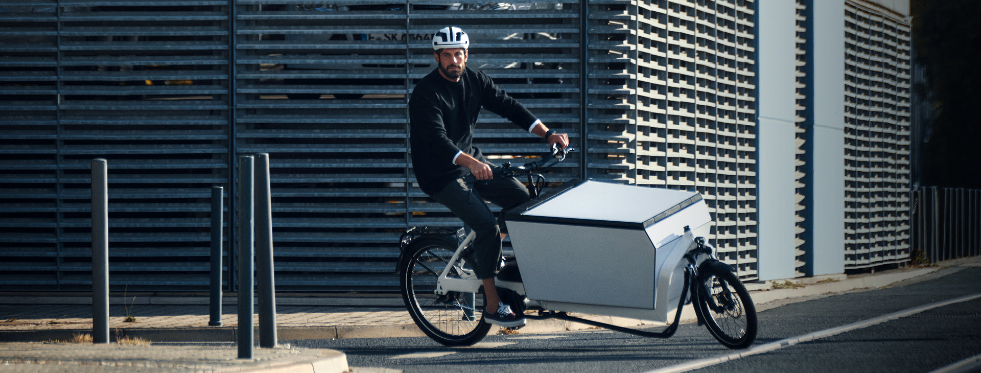 A man riding a Riese and Muller Transporter2 85 electric cargo bike